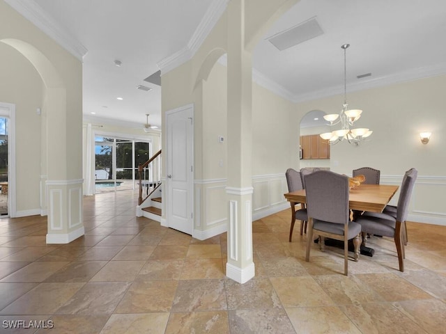 dining space with ornamental molding and an inviting chandelier