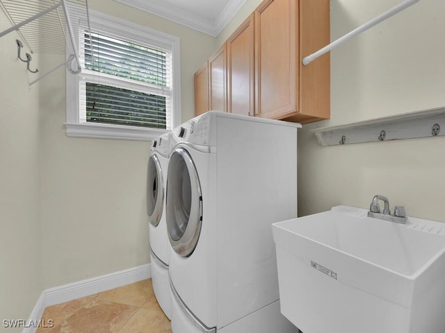 laundry room featuring cabinets, crown molding, sink, separate washer and dryer, and light tile patterned flooring