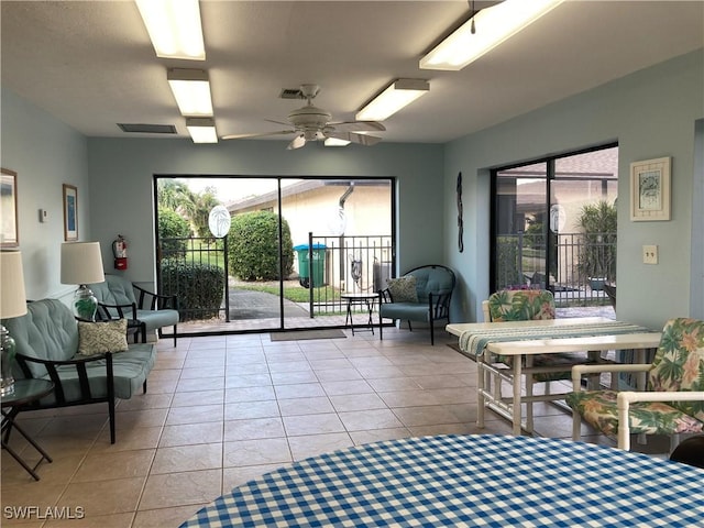 3923 SE 11th Ave Unit 304, Cape Coral, FL 33904 - tiled living area with a ceiling fan and plenty of natural light
