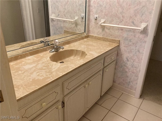 3923 SE 11th Ave Unit 304, Cape Coral, FL 33904 - bathroom featuring tile patterned floors, baseboards, vanity, and wallpapered walls