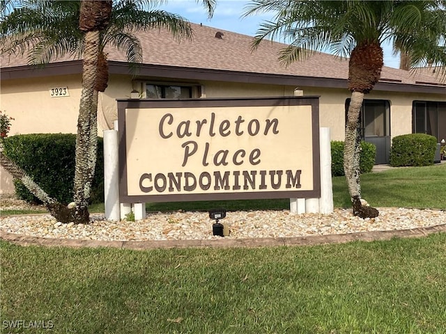 community / neighborhood sign with a lawn