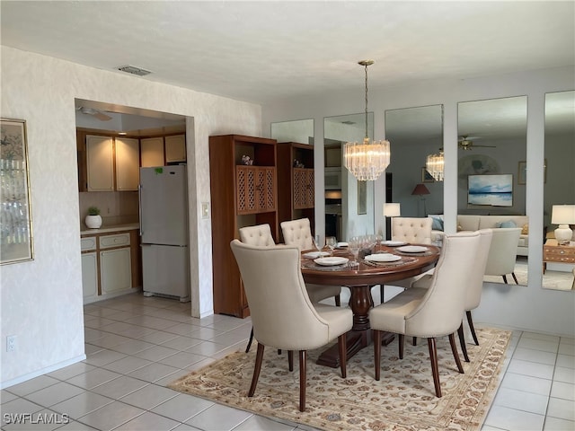 3923 SE 11th Ave Unit 304, Cape Coral, FL 33904 - dining room featuring a chandelier, light tile patterned floors, and a ceiling fan