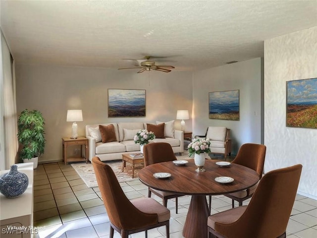 3923 SE 11th Ave Unit 304, Cape Coral, FL 33904 - dining space with light tile patterned floors, a ceiling fan, and a textured ceiling