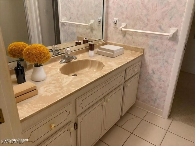 3923 SE 11th Ave Unit 304, Cape Coral, FL 33904 - bathroom featuring tile patterned floors, vanity, baseboards, and wallpapered walls