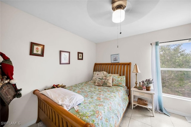 tiled bedroom featuring ceiling fan