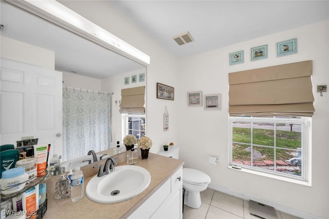 bathroom with tile patterned flooring, vanity, and toilet