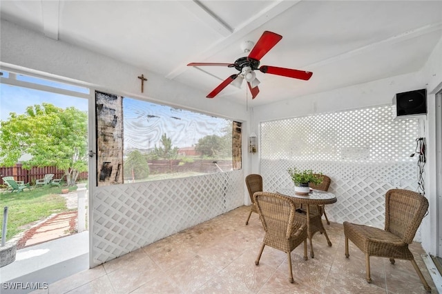 sunroom featuring ceiling fan