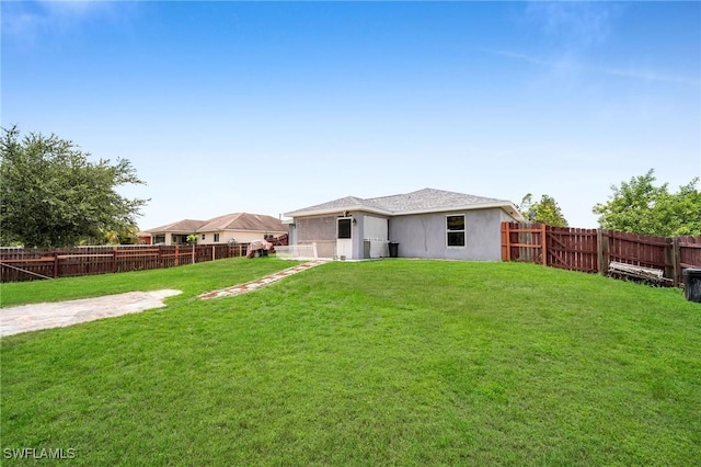 rear view of property featuring a yard