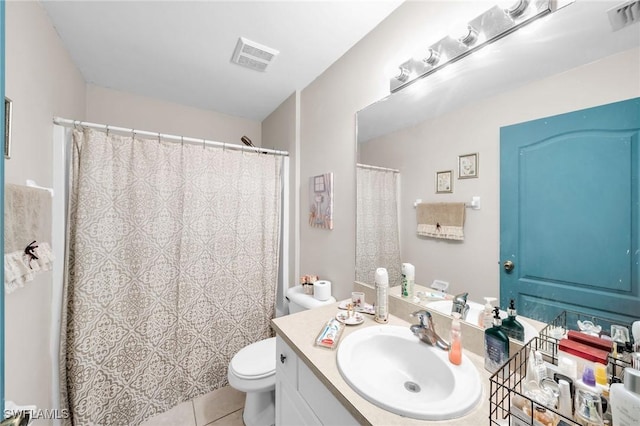 bathroom with tile patterned floors, vanity, and toilet