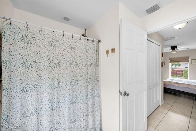 bathroom featuring tile patterned flooring and ceiling fan