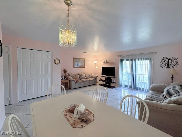 dining room featuring light tile patterned flooring and a chandelier