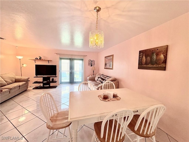 tiled dining space featuring a notable chandelier