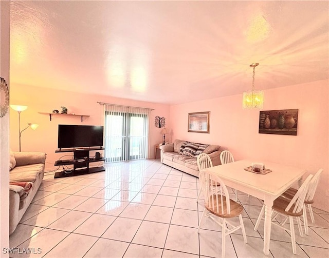 dining room with light tile patterned floors and an inviting chandelier