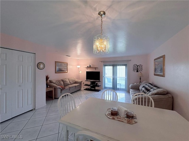 tiled dining room with a notable chandelier