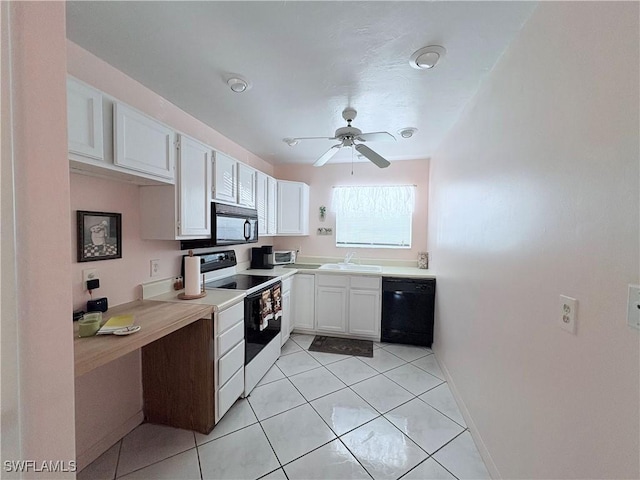 kitchen featuring ceiling fan, sink, light tile patterned floors, white cabinets, and black appliances