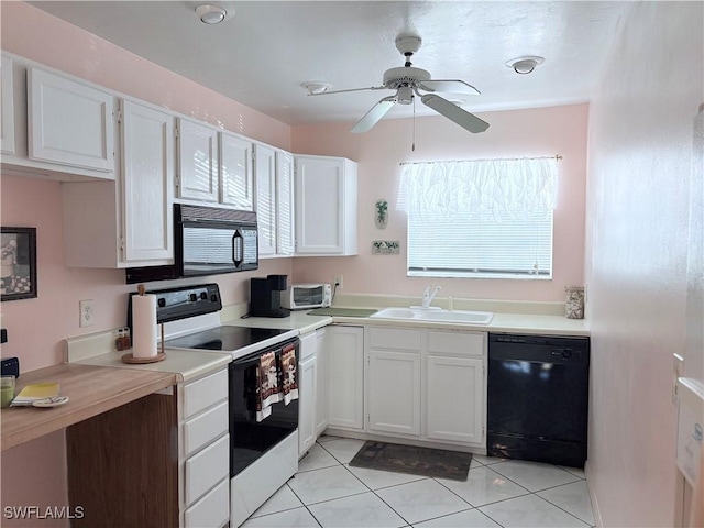 kitchen with ceiling fan, sink, black appliances, light tile patterned floors, and white cabinets