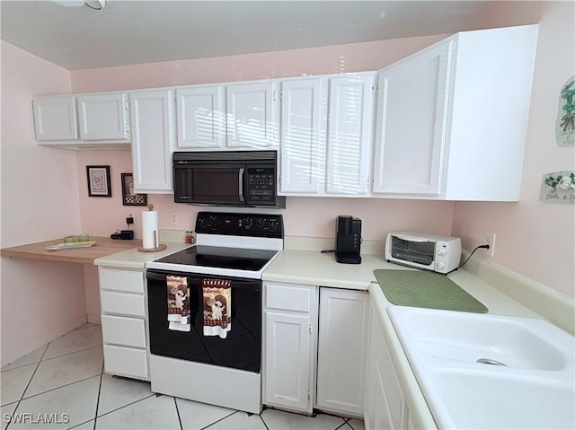 kitchen with white cabinets, white electric range oven, light tile patterned flooring, and sink