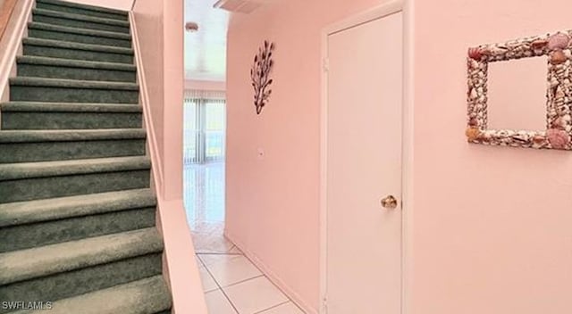 staircase featuring tile patterned floors