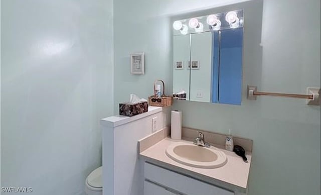 bathroom with vanity and toilet