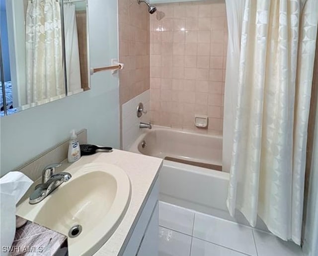 bathroom featuring tile patterned floors, vanity, and shower / tub combo