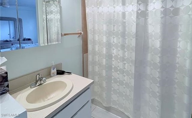 bathroom featuring vanity and shower / bathtub combination with curtain