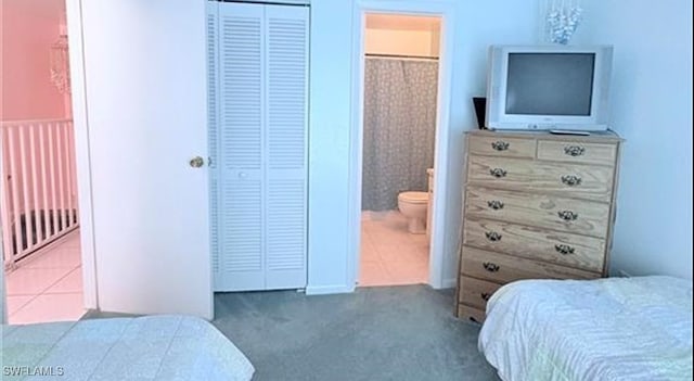 carpeted bedroom featuring ensuite bath