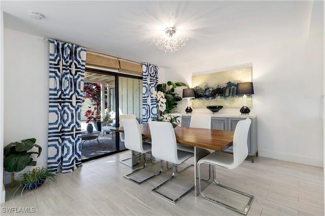 dining room with a chandelier and light wood-type flooring