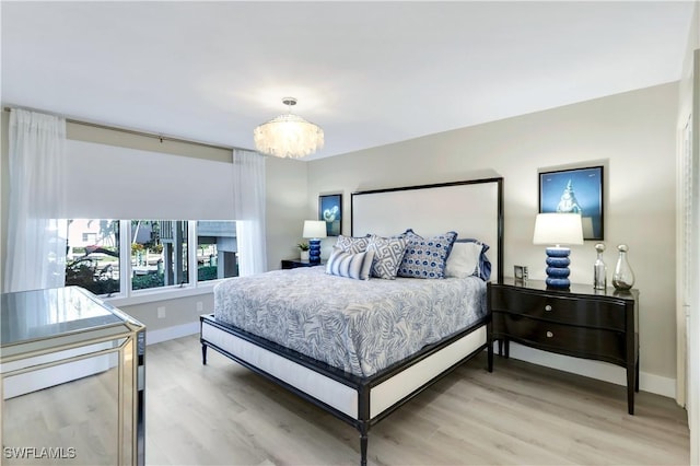 bedroom featuring hardwood / wood-style flooring and an inviting chandelier