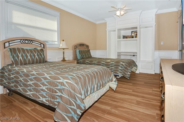 bedroom featuring crown molding, ceiling fan, a closet, and light hardwood / wood-style floors