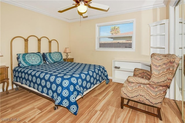 bedroom with light hardwood / wood-style floors, ceiling fan, and crown molding