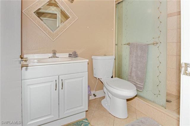 bathroom featuring tile patterned floors, vanity, tiled shower, and toilet