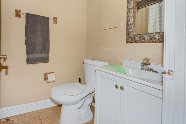 bathroom featuring tile patterned flooring, vanity, and toilet