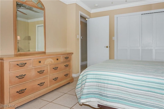 bedroom with crown molding, a closet, and light tile patterned flooring