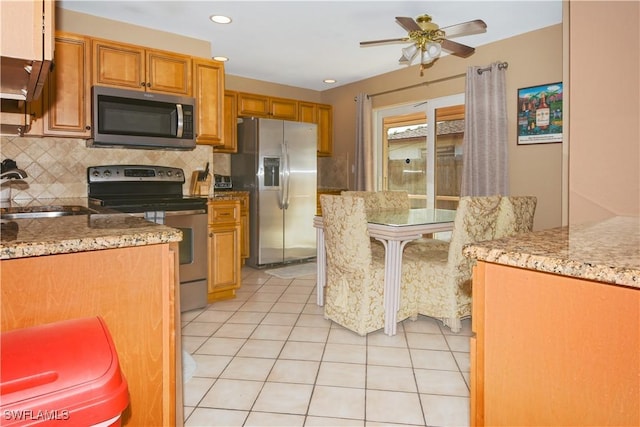 kitchen with tasteful backsplash, stainless steel appliances, ceiling fan, sink, and light tile patterned floors