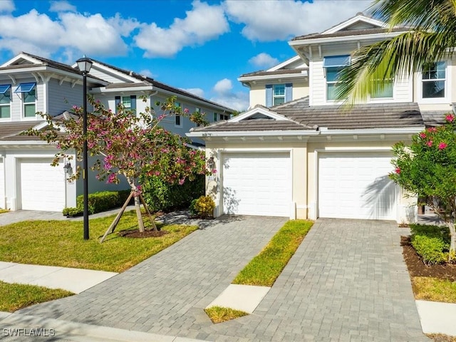 view of front of house featuring a garage and a front lawn