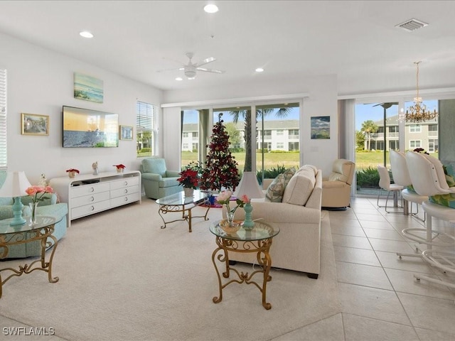 living room with ceiling fan, light tile patterned flooring, and a healthy amount of sunlight