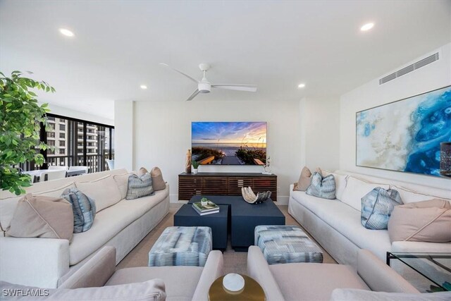 living room with hardwood / wood-style flooring and ceiling fan