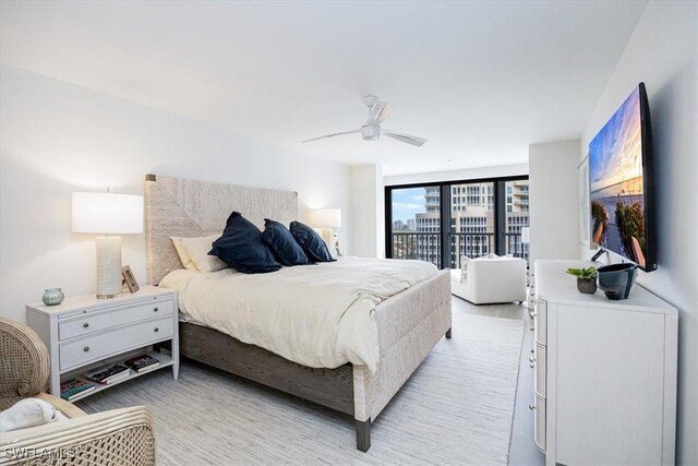 bedroom featuring ceiling fan, expansive windows, and access to outside