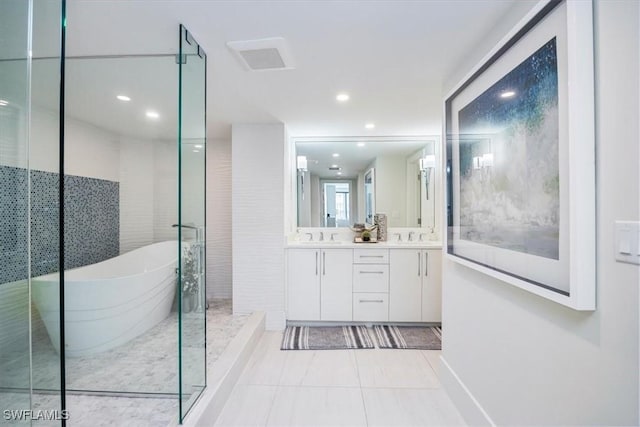 bathroom featuring plus walk in shower, tile patterned flooring, and vanity