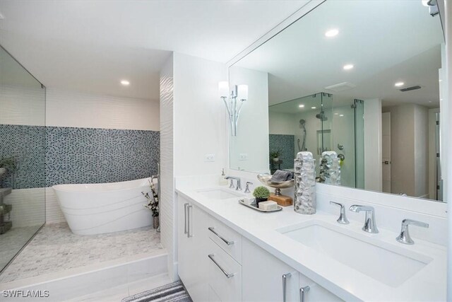 bathroom with vanity, tile walls, and independent shower and bath