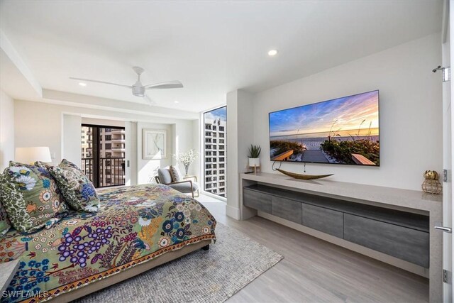 bedroom with access to exterior, light hardwood / wood-style floors, and ceiling fan