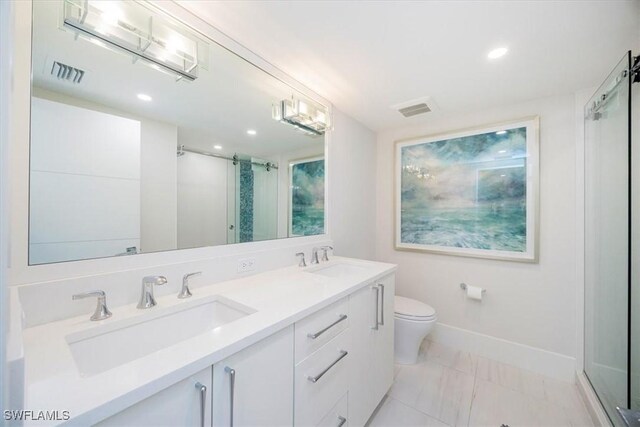 bathroom with vanity, an enclosed shower, and toilet