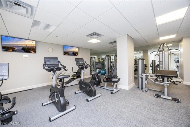 exercise room with a drop ceiling and carpet floors