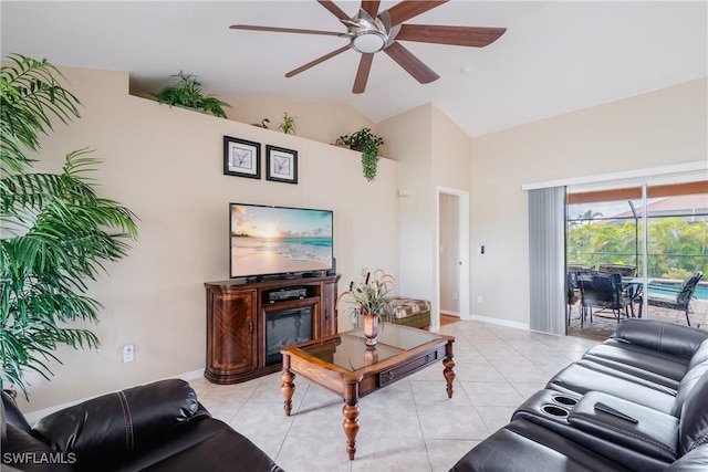 living room with ceiling fan, light tile patterned floors, and lofted ceiling