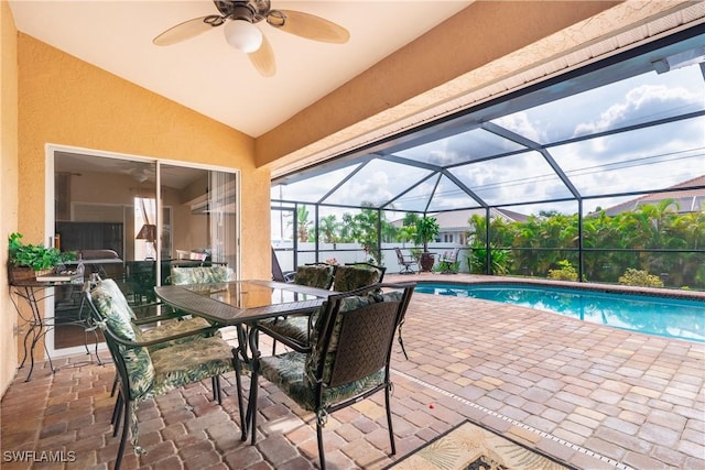 view of swimming pool with a lanai, ceiling fan, and a patio