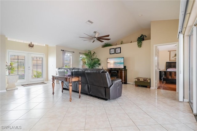 tiled living room with ceiling fan, high vaulted ceiling, and french doors