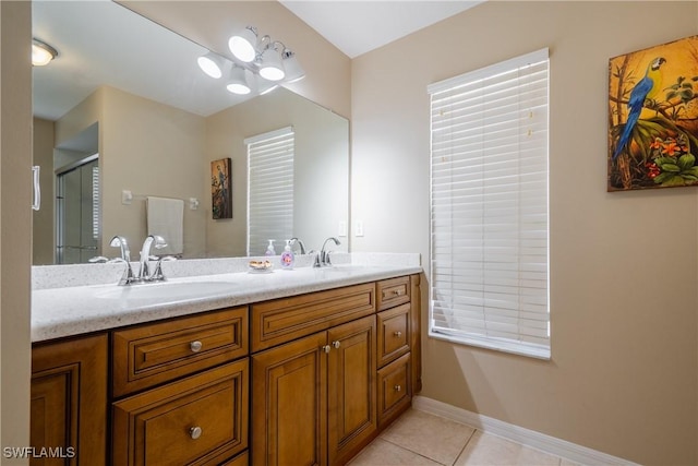 bathroom with tile patterned flooring, vanity, and an enclosed shower