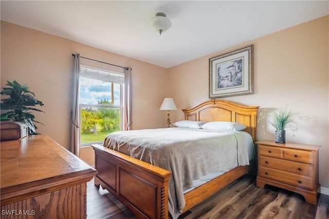 bedroom with dark hardwood / wood-style flooring