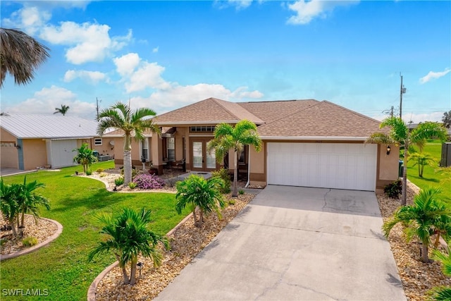 3505 Surfside Blvd, Cape Coral, FL 33914 - view of front facade featuring french doors, a garage, and a front lawn