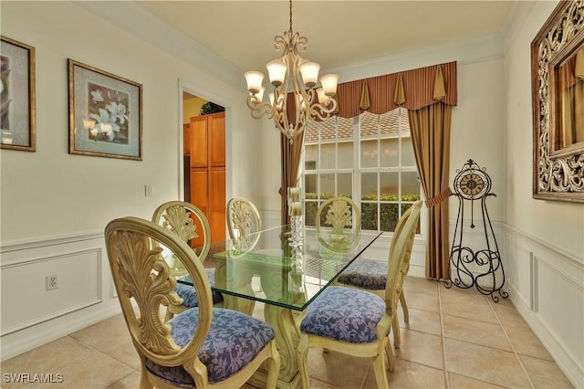 dining area with light tile patterned floors, a chandelier, and ornamental molding